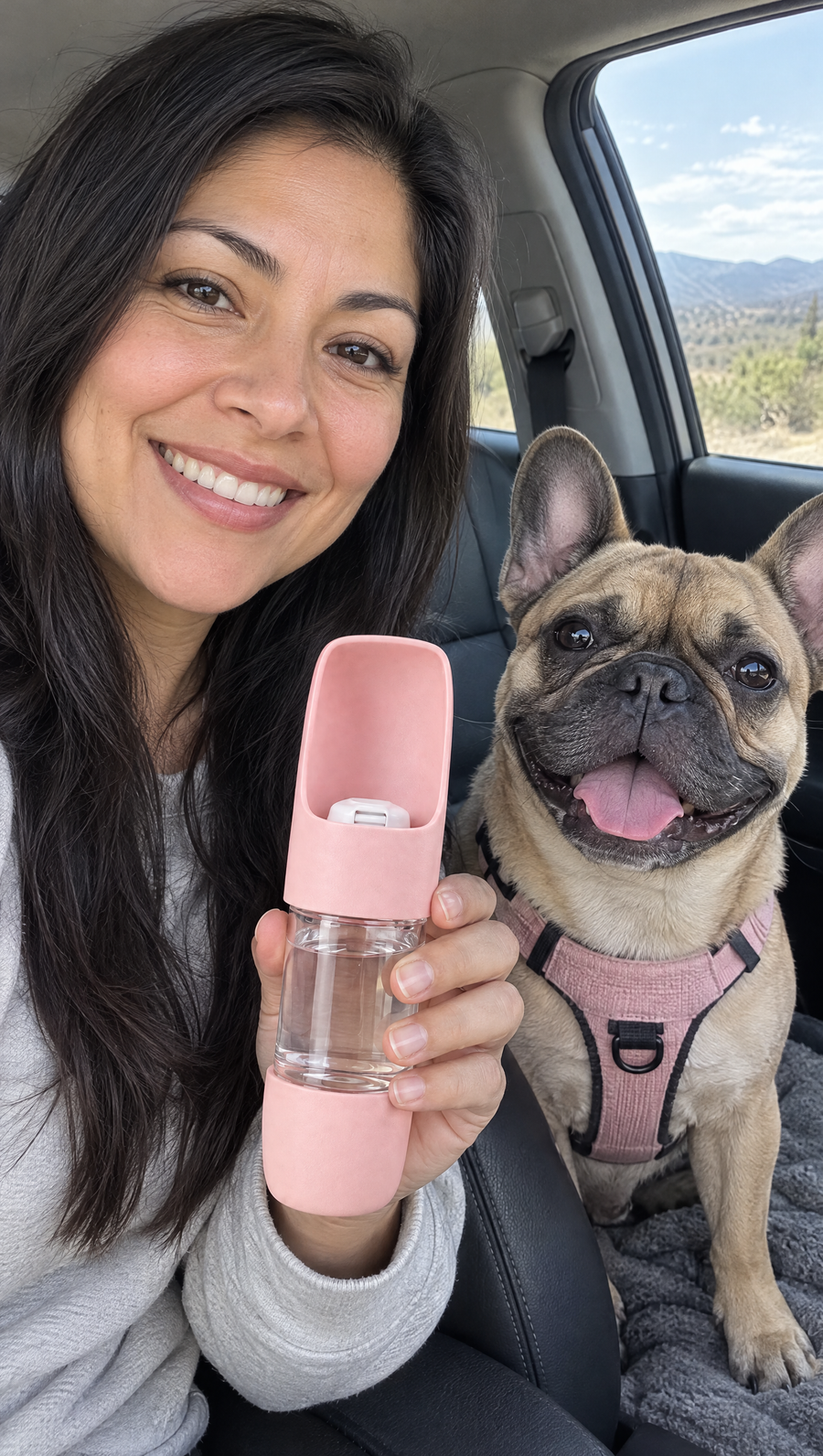 Woman taking a car selfie with her french bulldog and a pink TGTDIV bottle